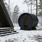 SaunaLife E6 Ergo 3-person outdoor barrel sauna in black finish in a snowy forest