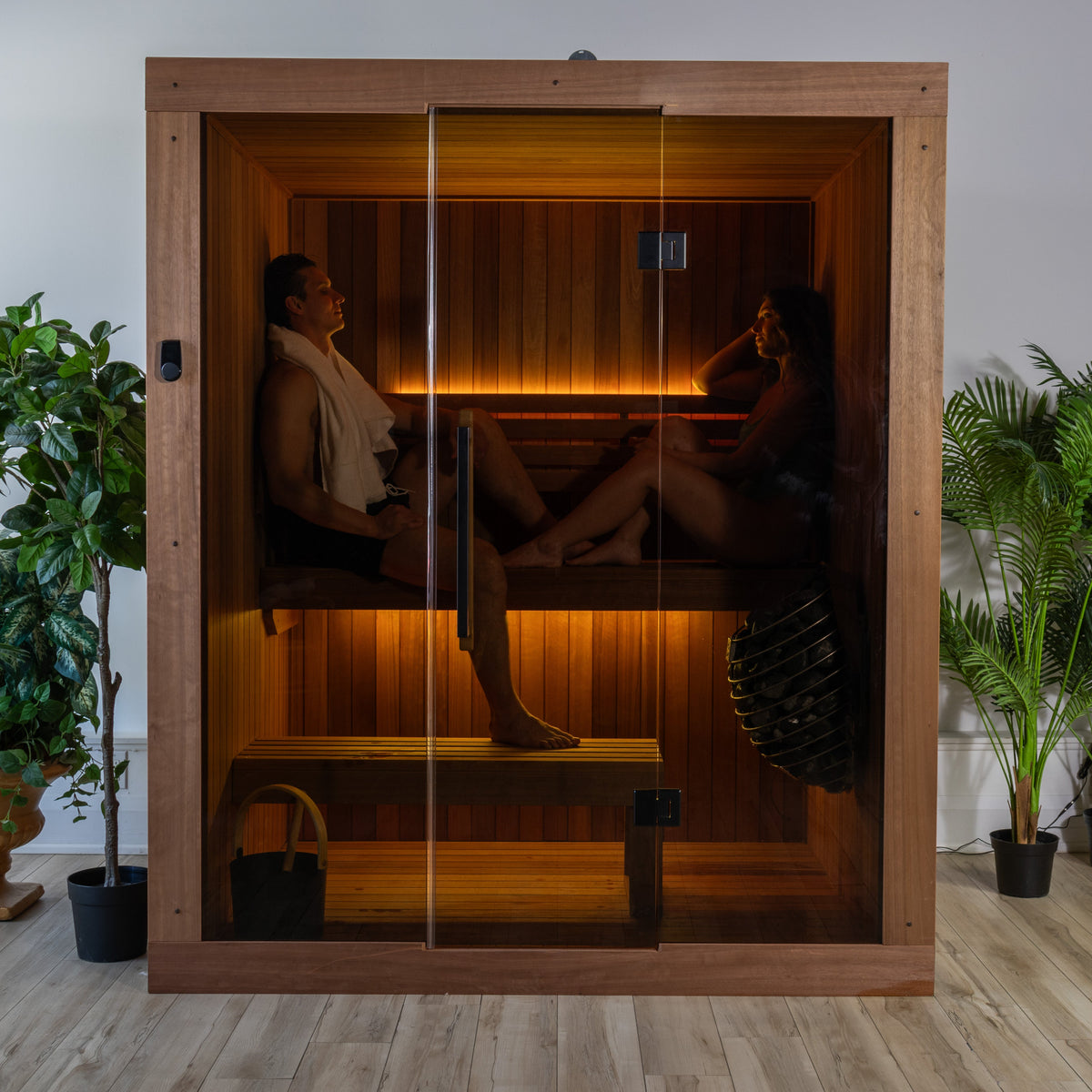 Guests relaxing inside the Dundalk Leisurecraft Element Loft 3 Person Traditional Indoor Sauna