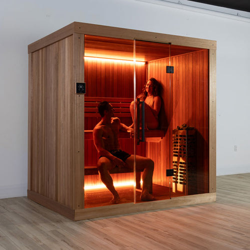 Two people relaxing inside the Dundalk Leisurecraft Element Studio 4 Person Traditional Indoor Sauna