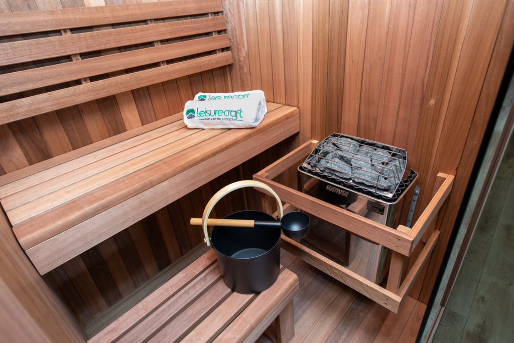 Heater, bucket and benches inside the Dundalk Leisurecraft Element Nook 1-2 Person Traditional Indoor Sauna