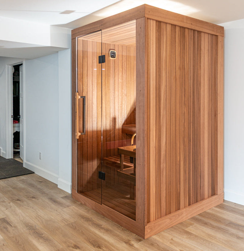 Angled view of the Dundalk Leisurecraft Element Nook 1-2 Person Traditional Indoor Sauna in a modern room