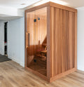 Angled view of the Dundalk Leisurecraft Element Nook 1-2 Person Traditional Indoor Sauna in a modern room