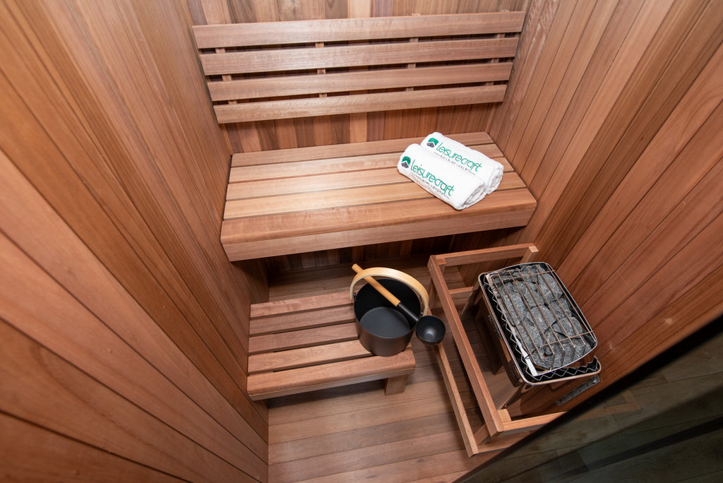Benches and heater inside the Dundalk Leisurecraft Element Nook 1-2 Person Traditional Indoor Sauna