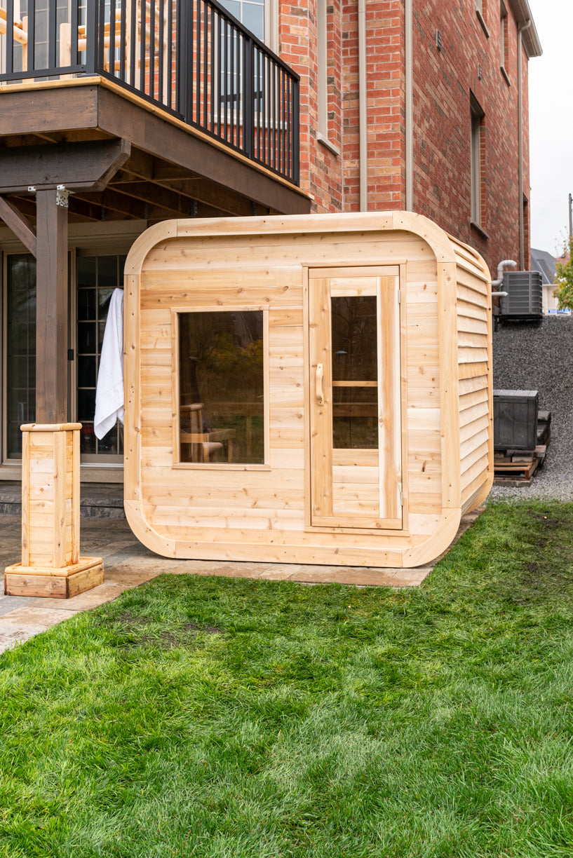 Dundalk CT Luna 4-Person Outdoor Sauna beside a house on a lawn