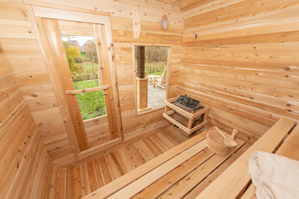 Window, heater and benches inside the Dundalk CT Luna 4-Person Outdoor Sauna