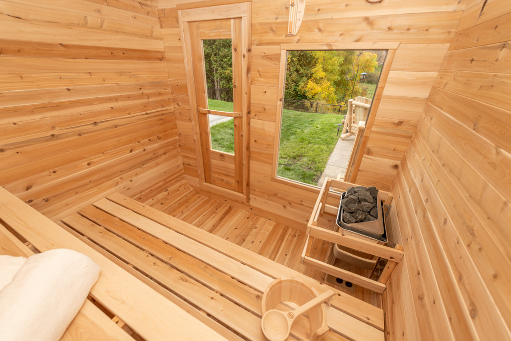 Heater, window and benches inside the Dundalk CT Luna 4-Person Outdoor Sauna