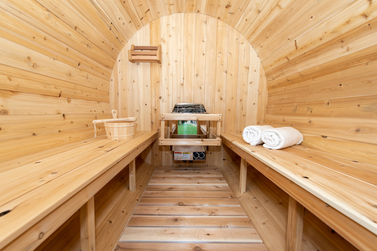 Interior of the Dundalk CT Harmony 4-Person Outdoor Barrel Sauna with benches and heater