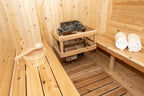 Heater and benches with towels inside the Dundalk CT Harmony 4-Person Outdoor Barrel Sauna
