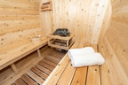 Heater and folded towel on the bench inside the Dundalk CT Harmony 4-Person Outdoor Barrel Sauna