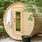 Front view of the Dundalk CT Harmony 4-Person Outdoor Barrel Sauna with towel hanging by the door
