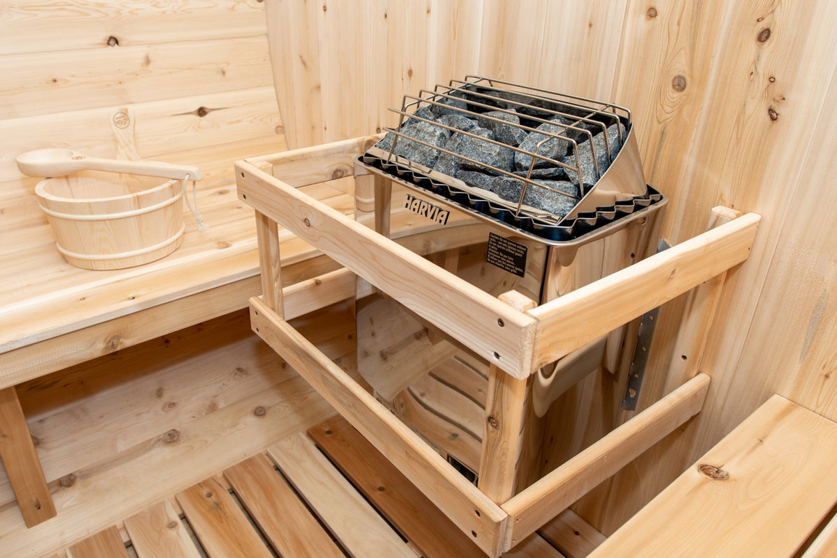 Heater with safety rail inside the Dundalk CT Tranquility 6-Person Outdoor Barrel Sauna