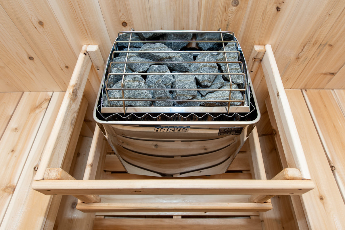 Heater stones in the safety rail inside the Dundalk CT Tranquility 6-Person Outdoor Barrel Sauna