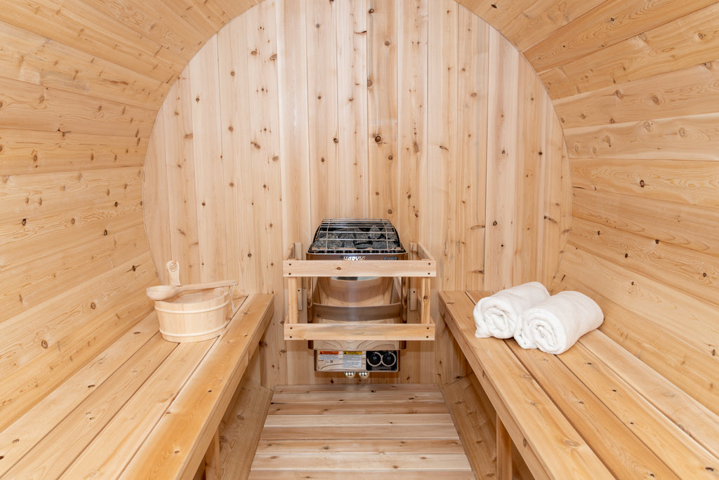 Heater and benches inside the Dundalk CT Tranquility 6-Person Outdoor Barrel Sauna