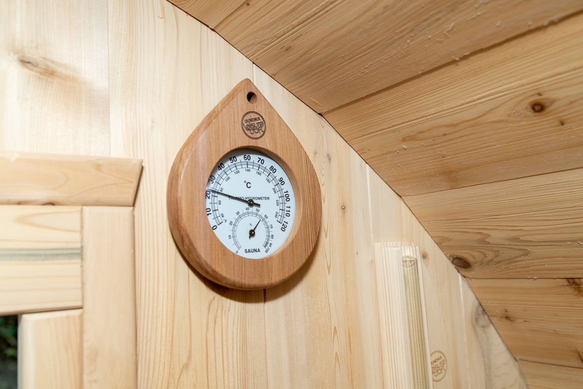 Clock and thermometer on the wall of the Dundalk CT Tranquility 6-Person Outdoor Barrel Sauna
