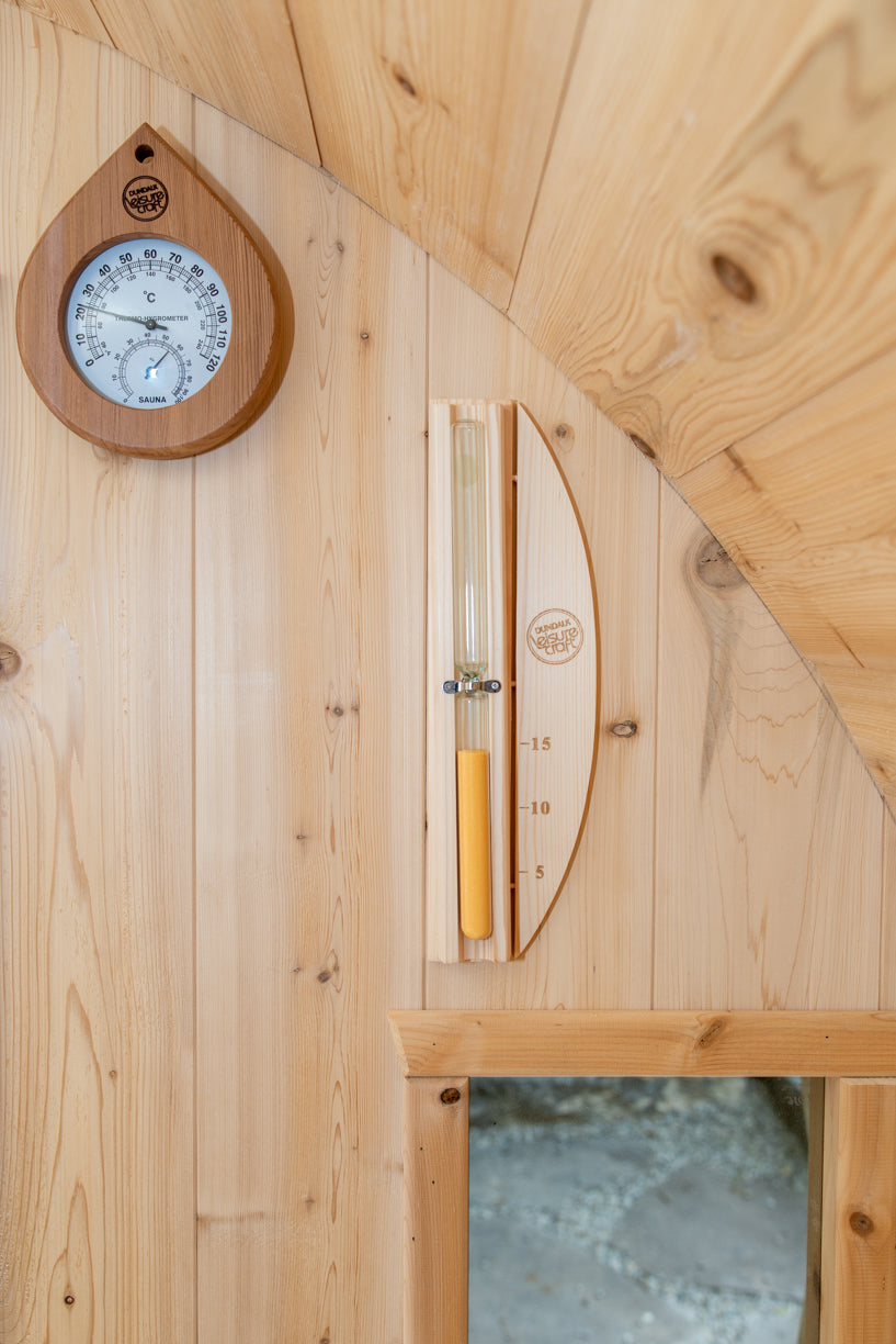 Thermometer and glass door inside the Dundalk CT Tranquility 6-Person Outdoor Barrel Sauna