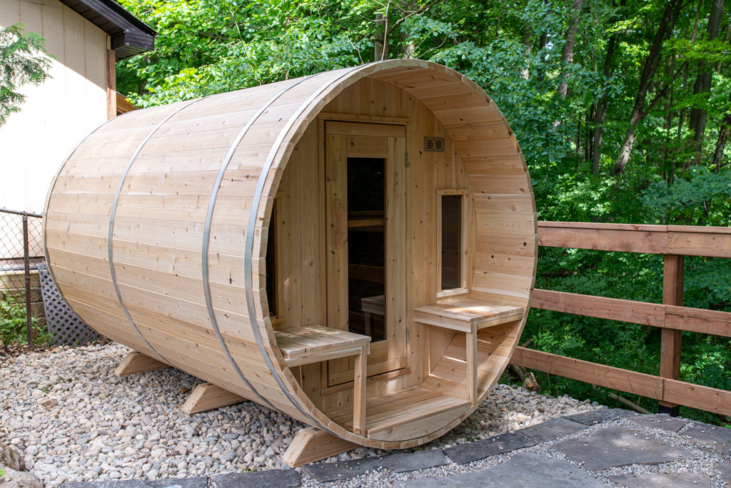Dundalk CT Tranquility 6-Person Outdoor Barrel Sauna on a deck beside a railing