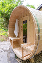 Front view of the Dundalk CT Tranquility 6-Person Outdoor Barrel Sauna with porch bench and open door