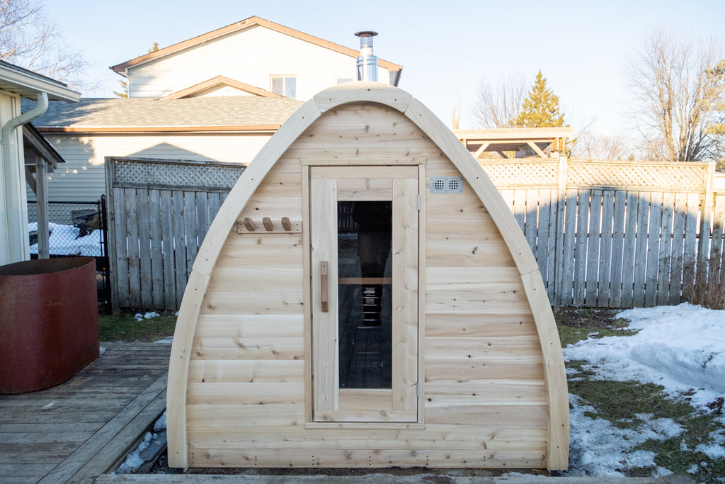 Angled front view of the Dundalk CT MiniPOD 4-Person Sauna with door and window