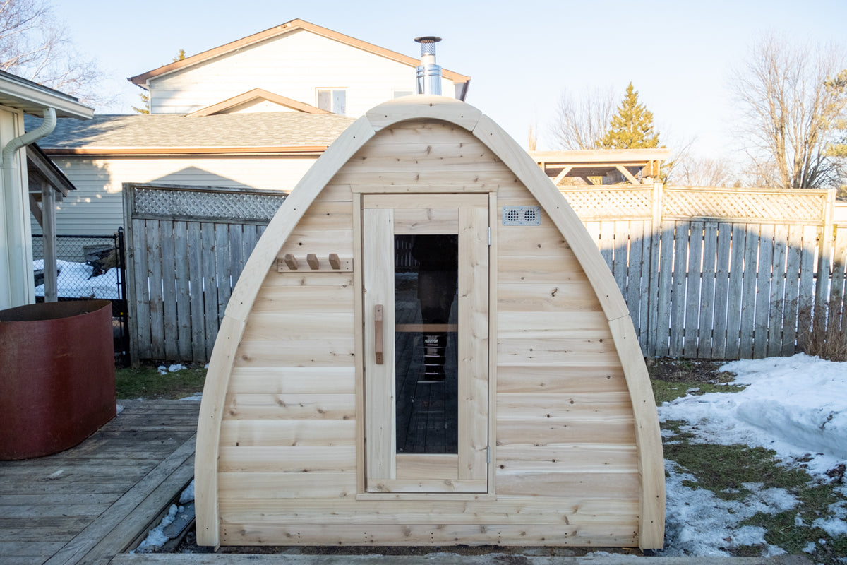 Angled front view of the Dundalk CT MiniPOD 4-Person Sauna with door and window