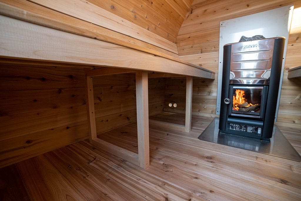 Interior of the Dundalk CT MiniPOD 4-Person Sauna with wooden benches and wood stove