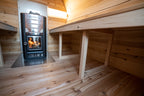 Interior of the Dundalk CT MiniPOD 4-Person Sauna with two-tier benches and wood stove