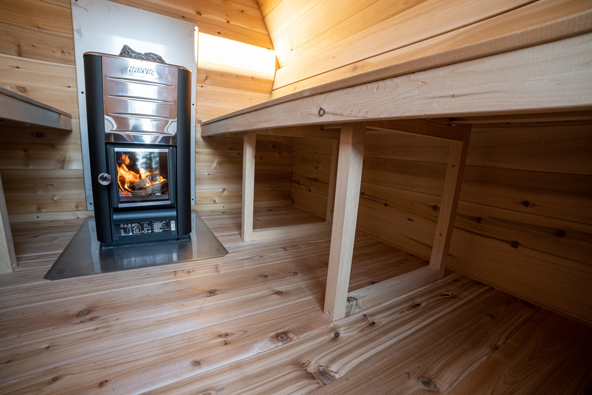 Interior of the Dundalk CT MiniPOD 4-Person Sauna with two-tier benches and wood stove