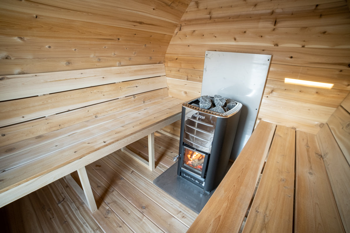 Wood stove and cedar benches inside the Dundalk CT MiniPOD 4-Person Sauna