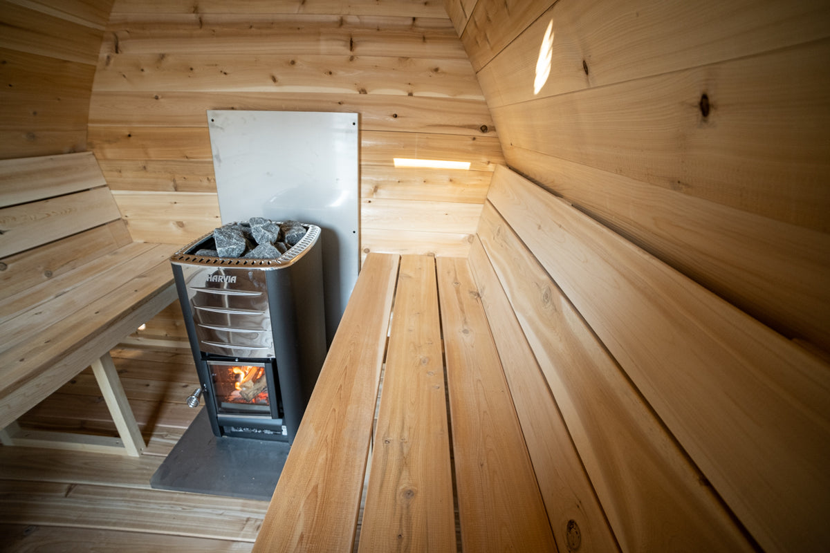 Cedar benches and wood stove inside the Dundalk CT MiniPOD 4-Person Sauna