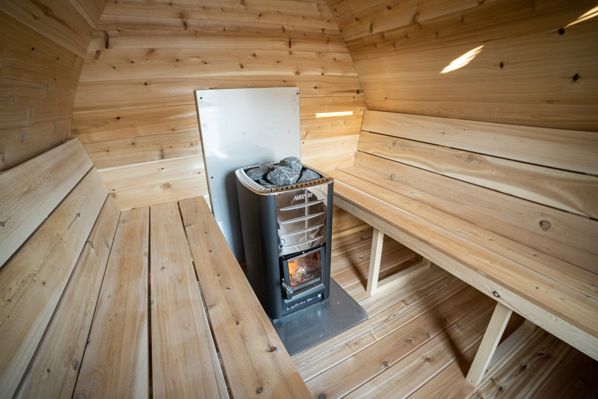 Interior of the Dundalk CT MiniPOD 4-Person Sauna with stove and stacked benches