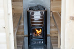 Wood stove with fire burning inside the Dundalk CT MiniPOD 4-Person Sauna