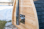 Side of the Dundalk CT MiniPOD 4-Person Sauna with stove chimney pipe in snow
