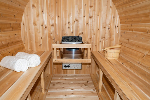 Interior of the Dundalk CT Serenity 5-Person Outdoor Barrel Sauna with heater, benches and towels