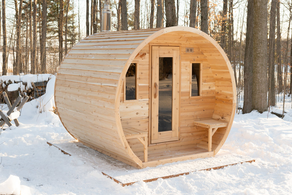 Front view of the Dundalk CT Elation 4-Person Outdoor Barrel Sauna in the snow