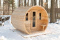 Front view of the Dundalk CT Elation 4-Person Outdoor Barrel Sauna in the snow