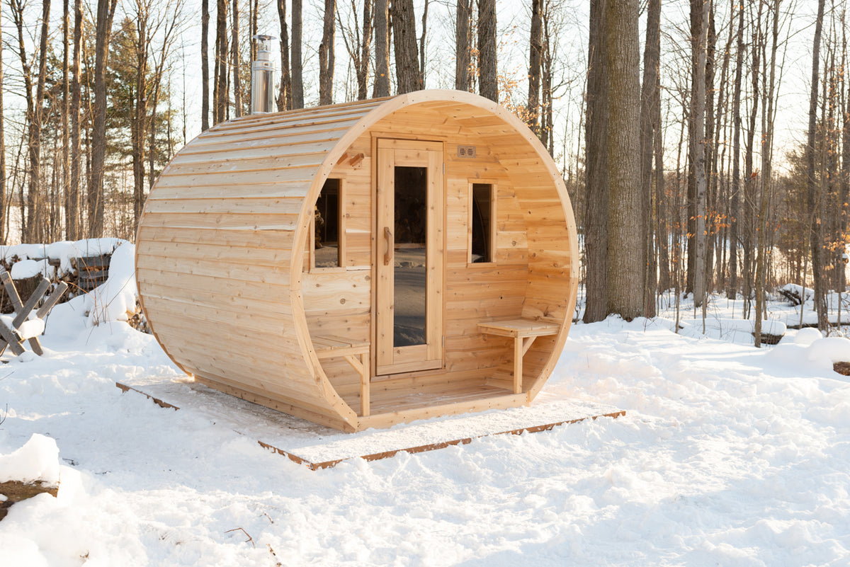 Dundalk CT Elation 4-Person Outdoor Barrel Sauna in a snowy forest