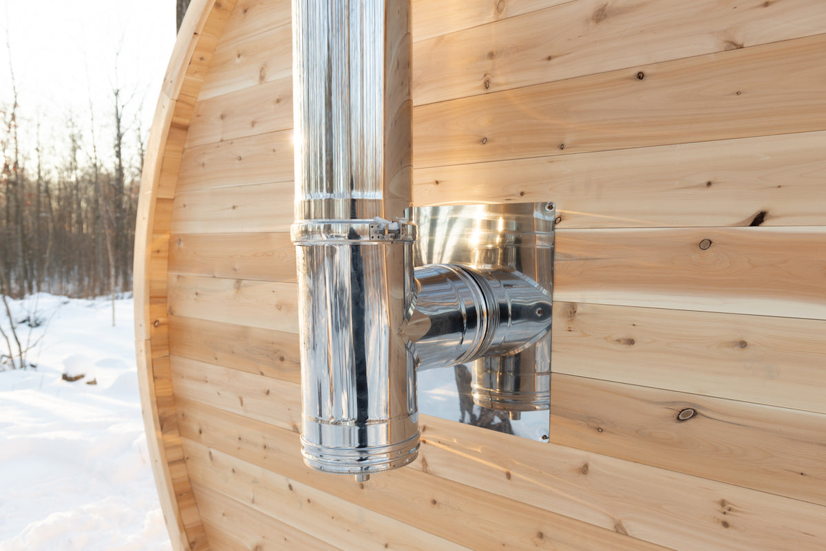 Stove chimney pipe on the side of the Dundalk CT Elation 4-Person Outdoor Barrel Sauna