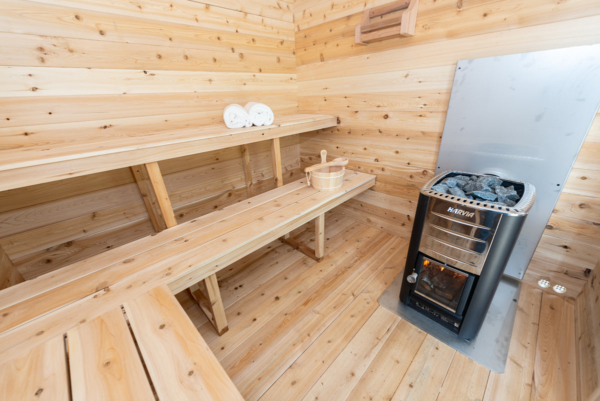 Interior of the Dundalk CT Georgian 6-Person Outdoor Cabin Sauna with stacked benches and heater