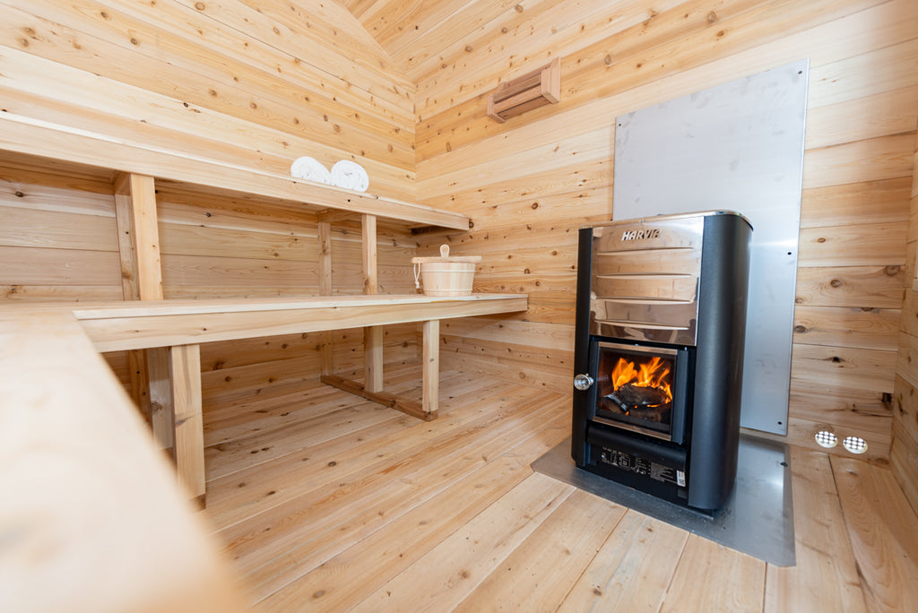 Wood-burning stove with glass door inside the Dundalk CT Georgian 6-Person Outdoor Cabin Sauna
