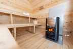 Wood-burning stove with glass door inside the Dundalk CT Georgian 6-Person Outdoor Cabin Sauna