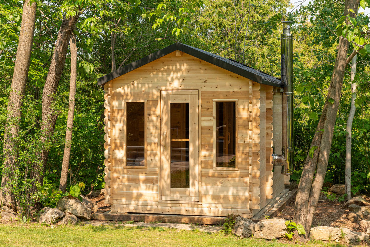 Front view of the Dundalk CT Georgian 6-Person Cabin Sauna with Change Room in a forest
