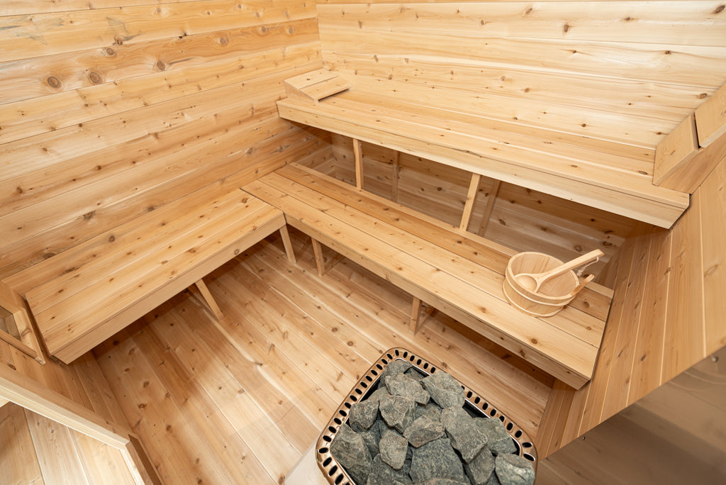 Corner benches and heater inside the Dundalk CT Georgian 6-Person Cabin Sauna with Change Room