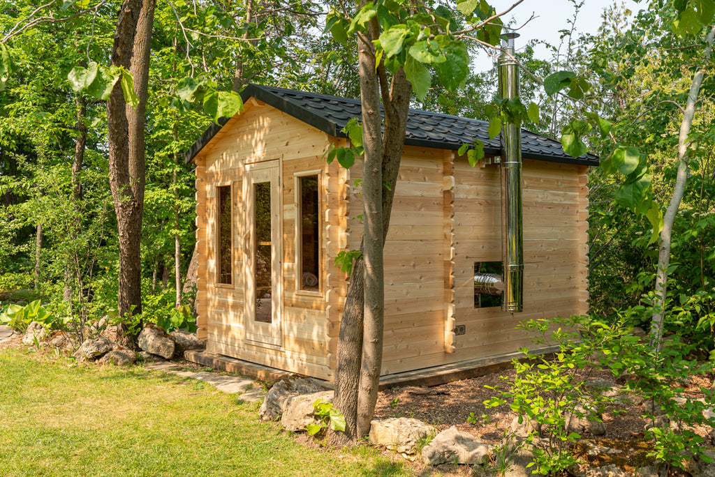 Side view of the Dundalk CT Georgian 6-Person Cabin Sauna with Change Room in a forest