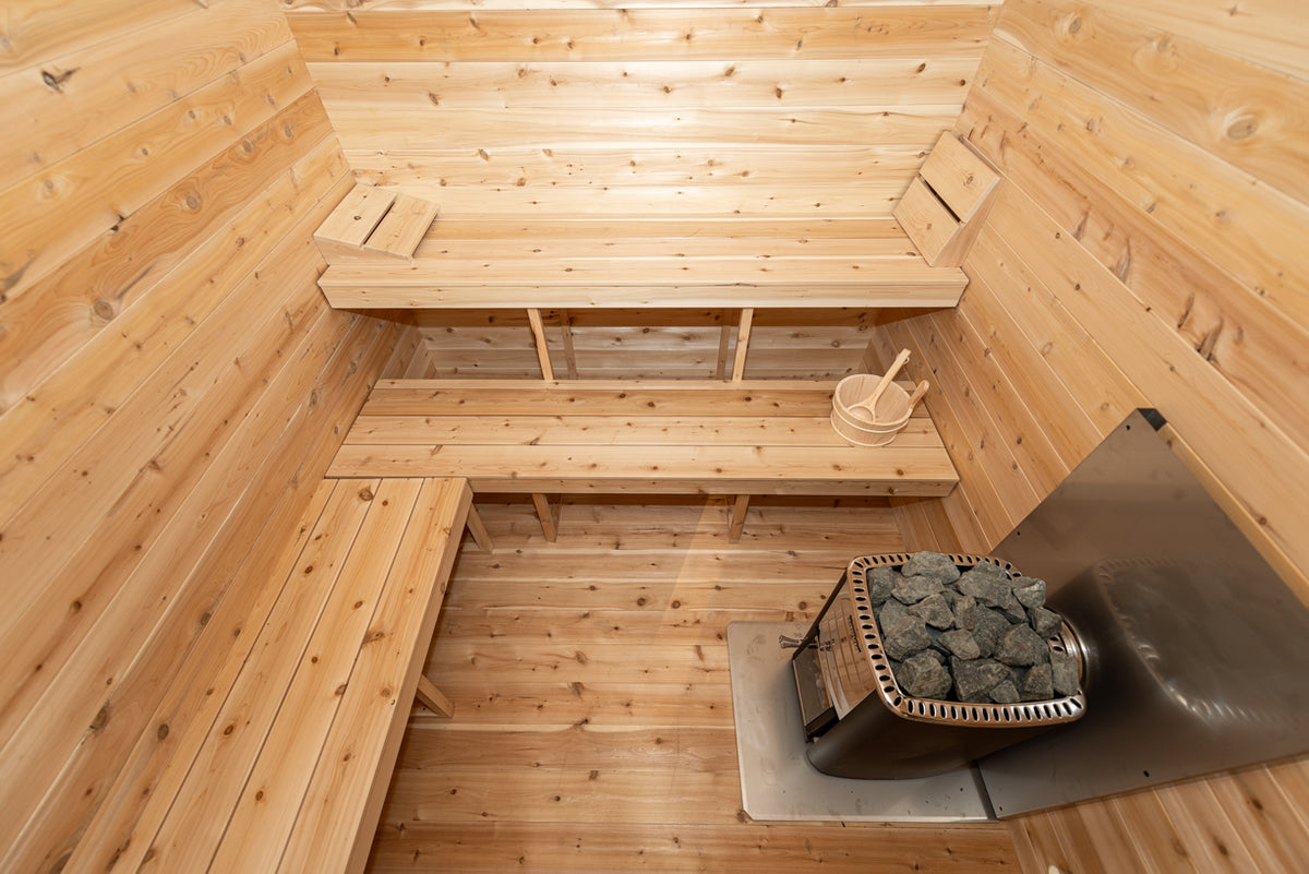 Benches and heater in the sauna room of the Dundalk CT Georgian 6-Person Cabin Sauna with Change Room