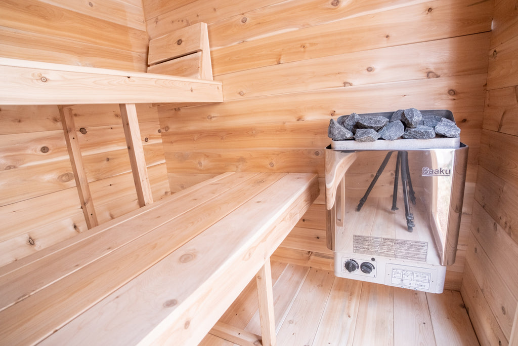 Heater and bench inside the Dundalk CT Granby 3-Person Outdoor Cabin Sauna