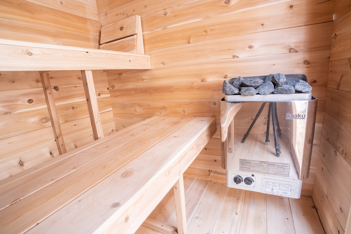 Heater and bench inside the Dundalk CT Granby 3-Person Outdoor Cabin Sauna