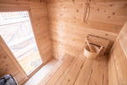 Heater, bench and window inside the Dundalk CT Granby 3-Person Outdoor Cabin Sauna