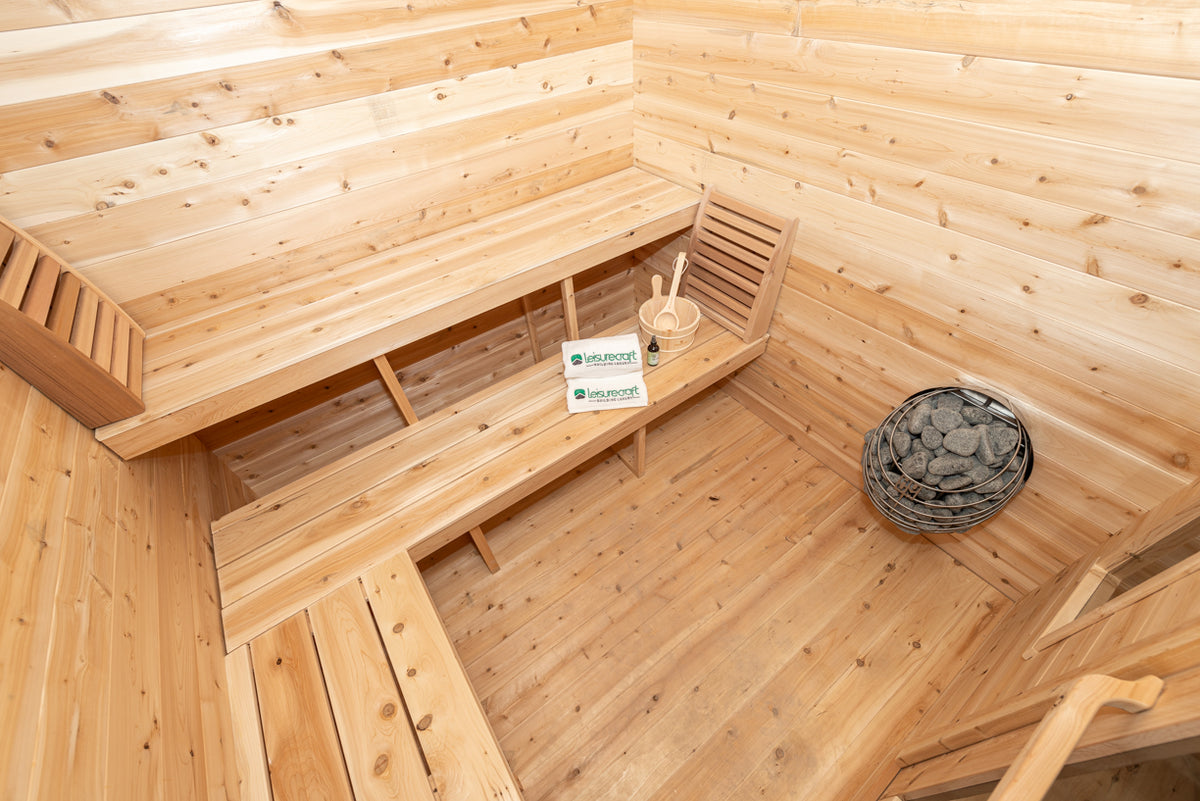 Heater and benches inside the Dundalk CT Georgian 6-Person Cabin Sauna with Porch