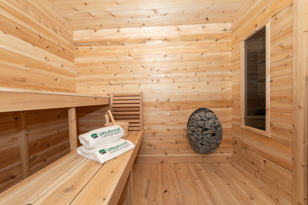 Benches with towels inside the Dundalk CT Georgian 6-Person Cabin Sauna with Porch
