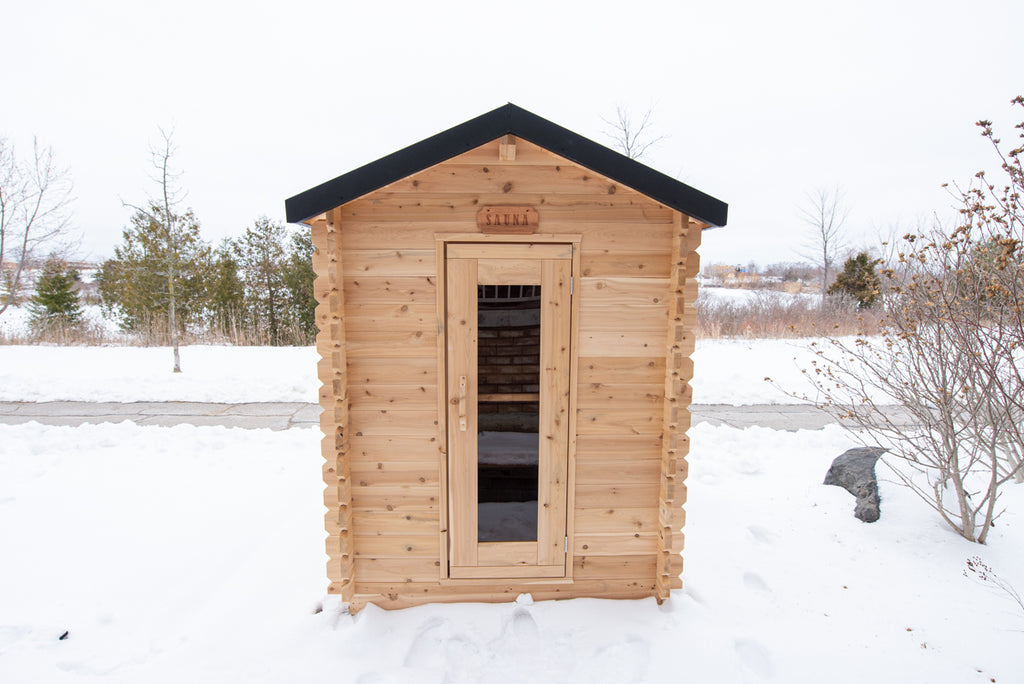 Front view of the Dundalk CT Granby 3-Person Outdoor Cabin Sauna in the snow