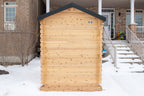 Rear view of the Dundalk CT Granby 3-Person Outdoor Cabin Sauna beside a house